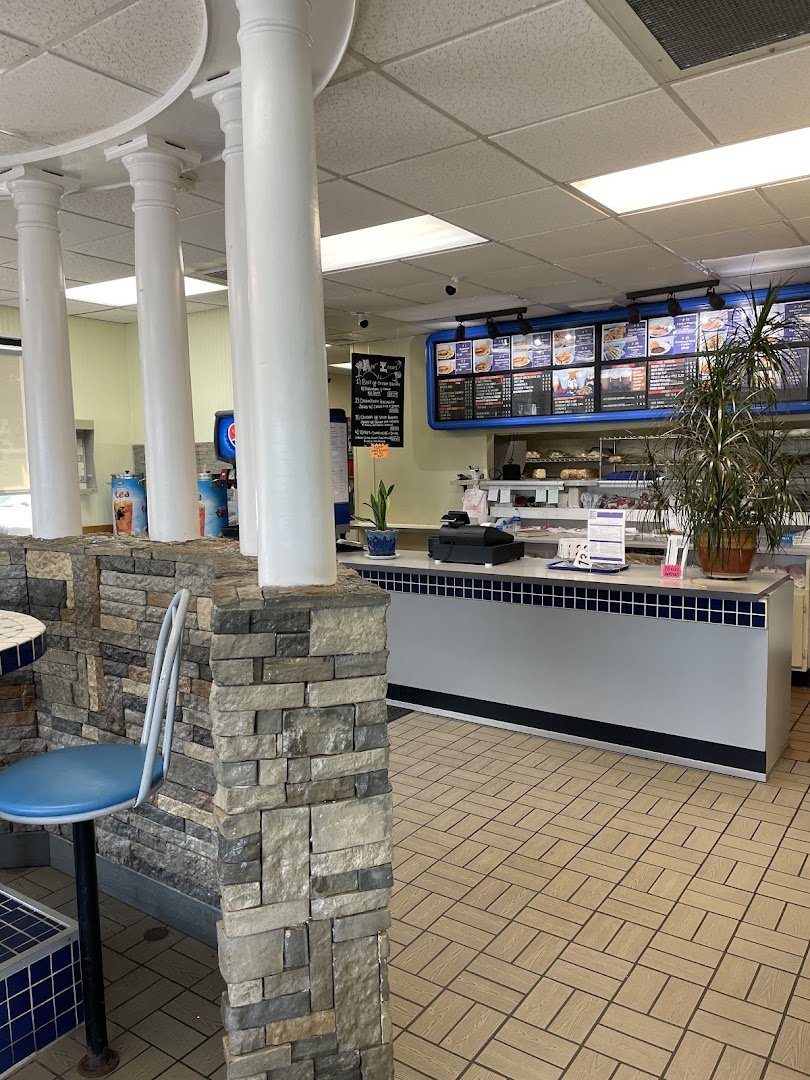 Casual American restaurant interior with simple tables and chairs.